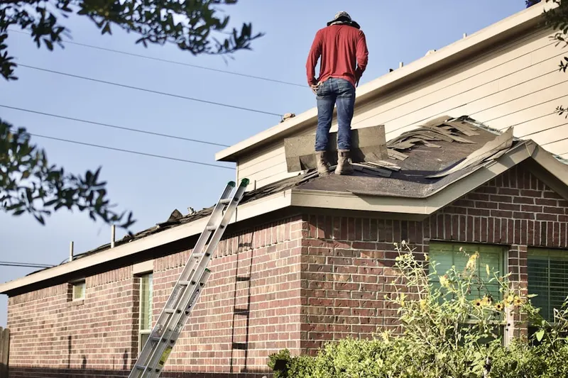 Professional roofer working on a residential roof in North Woodmere